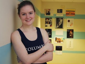 	Sophomore Ali Evarts stands in front of the new Kenneth P. Strong Gallery, in honor of professor Strong, who died of cancer in 2010.