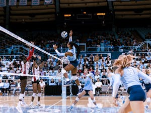 UNC senior middle hitter Skyy Howard (8) wins a point off of a hit in the second set of the volleyball match against Louisville on Sunday, Nov. 13, 2022. UNC fell 3-0 to Louisville.
