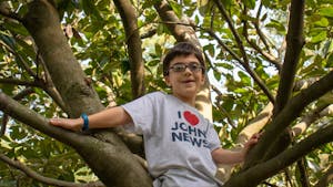 John Wortman, creator of John News on Youtube, poses for a portrait while climbing a tree on Sunday, Oct. 4, 2020.