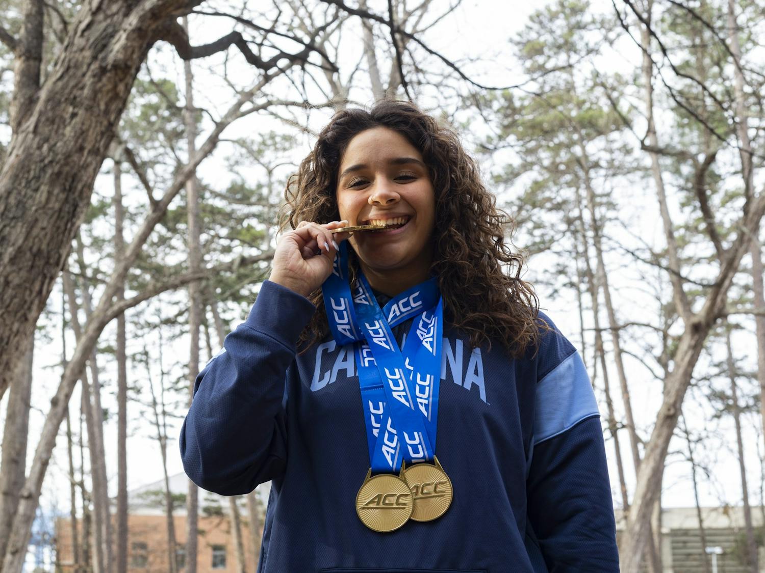 UNC junior diver Aranza Vazquez wears her three gold medals on Tuesday, Feb. 28, 2023. Vazquez earned the triple crown during the 2023 ACC Swimming and Diving Championships.