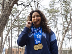UNC junior diver Aranza Vazquez wears her three gold medals on Tuesday, Feb. 28, 2023. Vazquez earned the triple crown during the 2023 ACC Swimming and Diving Championships.
