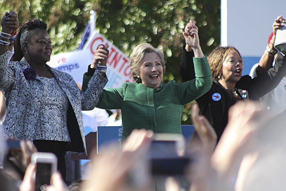 Democratic presidential nominee Hillary Clinton (center) holds hands with Mothers of the Movement members Sybrina Fulton (left), the mother of Trayvon Martin, and Lucy McBath (left), the mother of Jordan Davis. Mothers of the Movement is a group working to end police brutality.