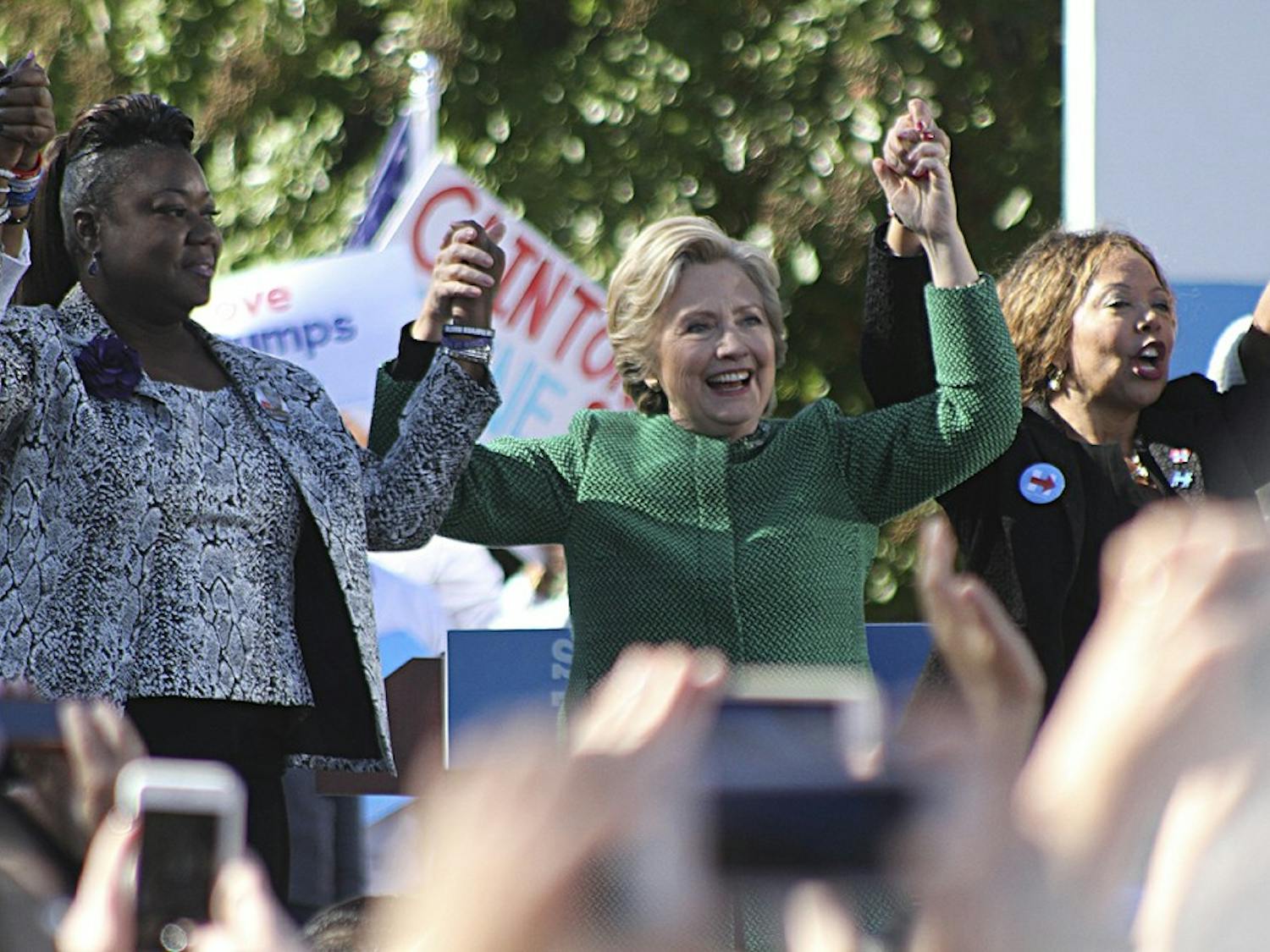 Democratic presidential nominee Hillary Clinton (center) holds hands with Mothers of the Movement members Sybrina Fulton (left), the mother of Trayvon Martin, and Lucy McBath (left), the mother of Jordan Davis. Mothers of the Movement is a group working to end police brutality.