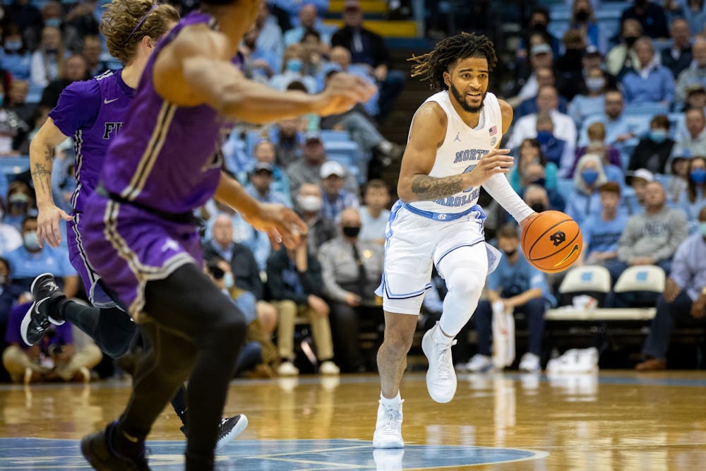 Sophomore guard RJ Davis (4) dribbles the ball down the court during the game against Furman on Tuesday, Dec. 14, 2021, at the Dean E. Smith Center. UNC won 74-61.
