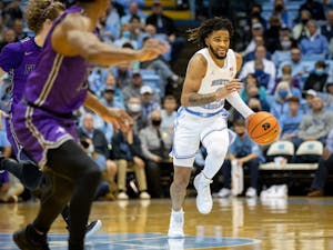 Sophomore guard RJ Davis (4) dribbles the ball down the court during the game against Furman on Tuesday, Dec. 14, 2021, at the Dean E. Smith Center. UNC won 74-61.