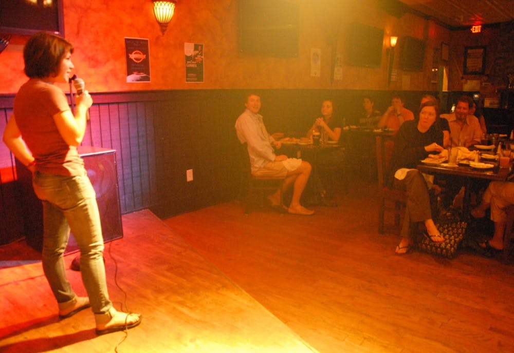 Senior English major Emily Satterfield cracks jokes during Comedian Night at Kildare’s Irish Pub and Grille on Tuesday night as an amused crowd looks on and laughs.  The local comedy scene in Chapel Hill has witnessed a takeoff in the last several years.