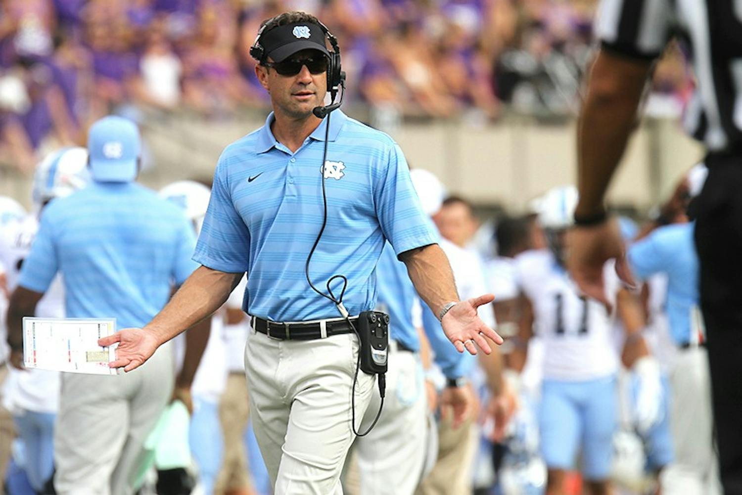 Larry Fedora questions a call to the referee. 