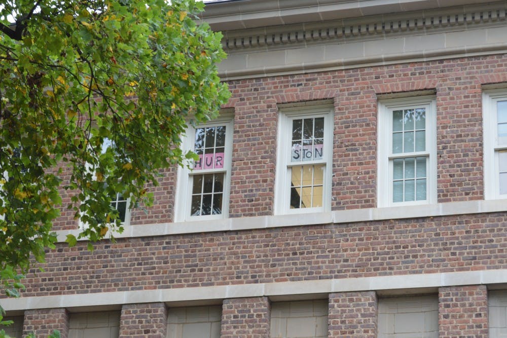 Professor Altha Cravey's third-floor office window displays a sign reading "Hurston" in the recently renamed Carolina Hall.