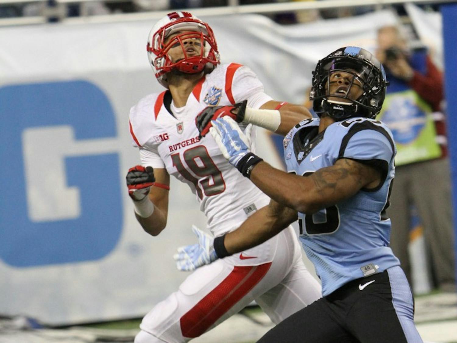 Rutgers senior wide receiver Andrew Turzilli (19) catches a touchdown pass over a Tar Heel defensive back in UNC's 40-21 loss to the Scarlett Knights in the Quick Lane Bowl.