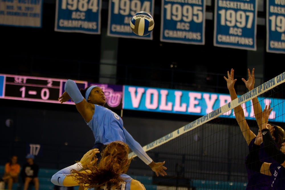 Senior middle hitter Skyy Howard (8) spikes the ball over the net. UNC beat High Point 3-2 at home on Saturday, Aug. 20, 2022. 