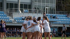 The UNC women's lacrosse team huddles together during the women’s lacrosse game against High Point at Dorrance Field on Thursday, March 23, 2023. UNC beat High Point 22-4.