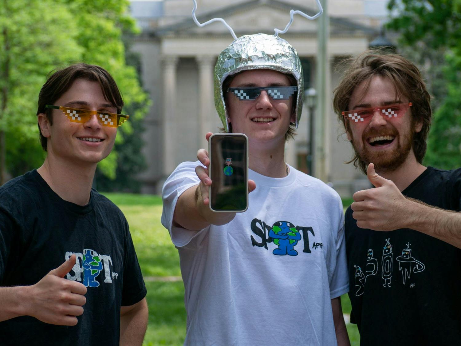 UNC alumni and developers of Sp0t, a new social media platform designed for UNC students, from left to right Kenny Barone, &nbsp;Riley Elliot and Tyler Trocinski, stand on Polk Place on Sunday, April 16, 2023.