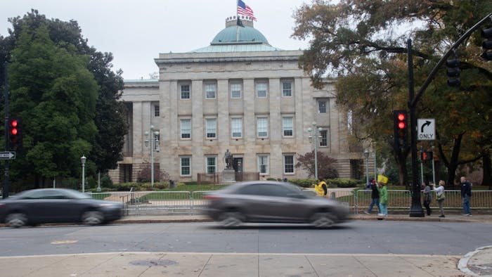 Cars pass by the North Carolina State Capitol building on Friday, Nov. 13, 2020. In the 2020 election, all of the incumbents in the council of state races won re-election or are leading over their opponent.