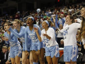 UNC women's basketball players cheer on their teammates from the bench during the second round of the ACC Tournament in Greensboro, N.C. on Friday, March 8, 2019. UNC lost to Notre Dame 95-77.