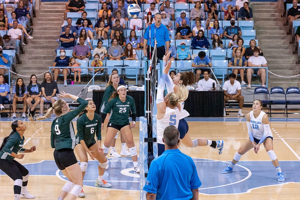 UNC junior middle hitter Kaya Merkler (14) hits the ball over the net during the volleyball match against Michigan State on Friday, Sept. 9, 2022, at Carmichael Arena.  UNC beat Michigan State 3-0.