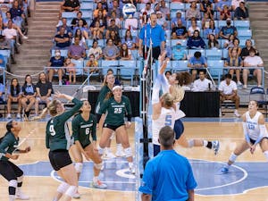 UNC junior middle hitter Kaya Merkler (14) hits the ball over the net during the volleyball match against Michigan State on Friday, Sept. 9, 2022, at Carmichael Arena.  UNC beat Michigan State 3-0.