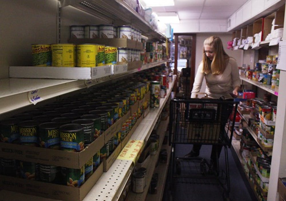 Erin Kabrick makes a meal bag Monday at the Inter-Faith Council for Social Service’s Food Pantry. DTH/Mary-Alice Warren