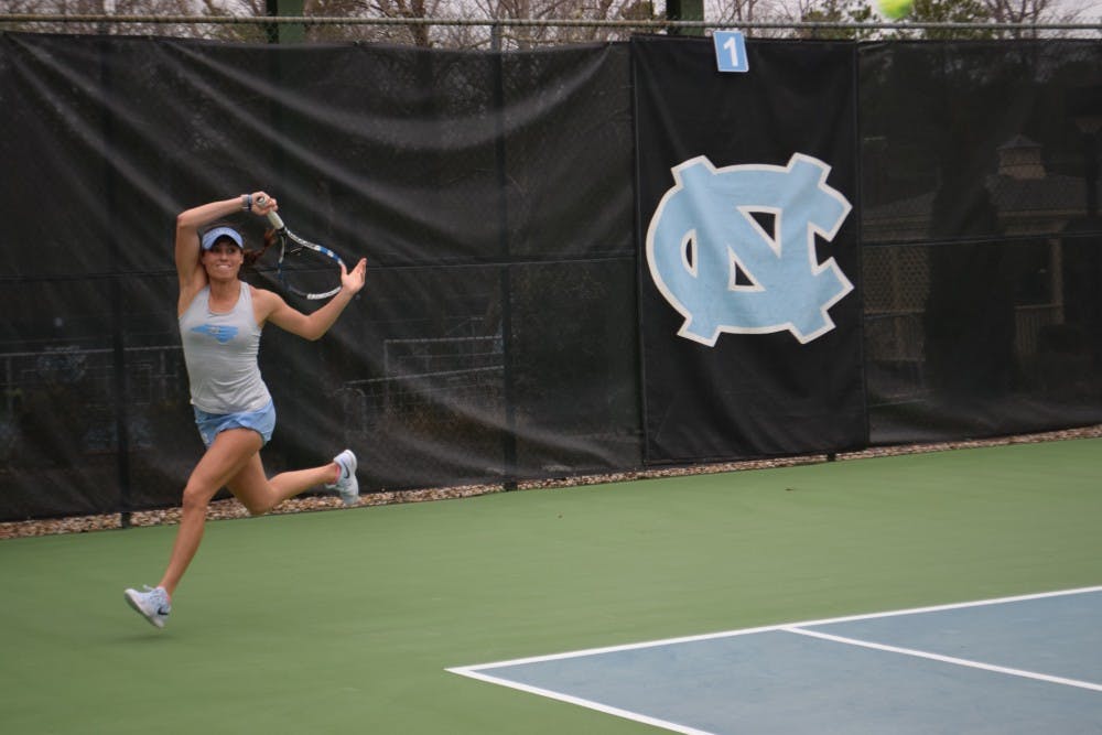 <p>Sophomore Alexa Graham follows through after a hit against N.C. State on Feb. 21 at the Cone-Kenfield Tennis Center.</p>