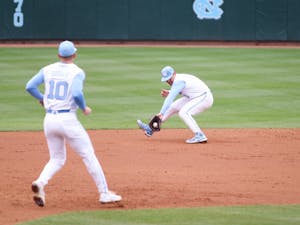Shortstop Danny Serretti (1) catches a groundball in his mitt as infielder Mac Horvath (10) runs towards him during a home baseball game against Pittsburgh. UNC won 4-3 on Saturday, March 12, 2022.