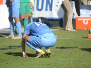 Forward Giovanni Montesdeoca (10) bends over in disappointment following Sunday's ACC Championship game at WakeMed Soccer Park. UNC lost to Louisville 1-0.
