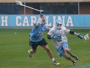 Midfielder William Perry (3) runs down the field during the game against Johns Hopkins in Kenan Memorial Stadium on Saturday, Feb. 23, 2019. UNC lost 10-11.