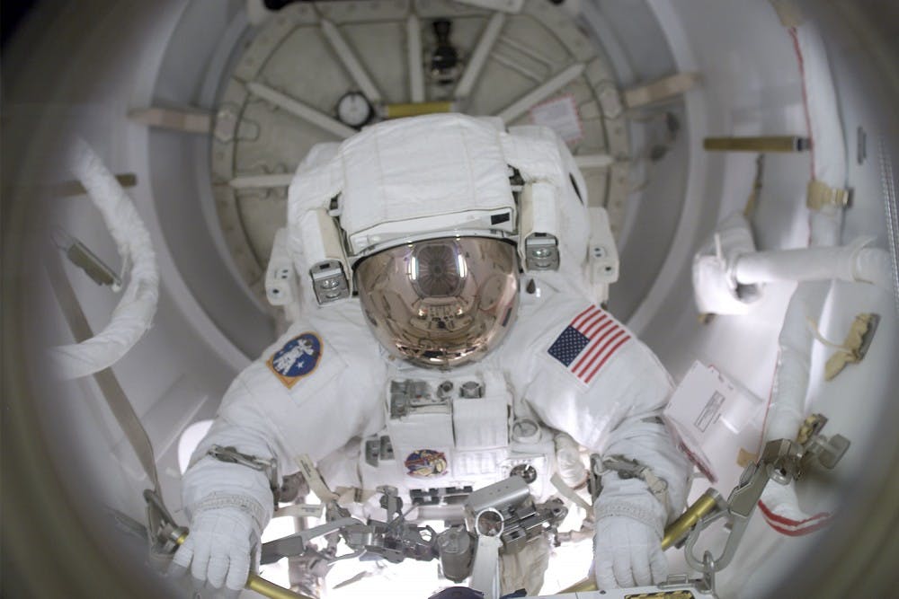 Courtesy of NASA. Astronaut John B. Herrington prepares to egress the airlock to begin the first of three scheduled STS-113 spacewalks for work.