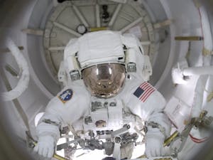 Courtesy of NASA. Astronaut John B. Herrington prepares to egress the airlock to begin the first of three scheduled STS-113 spacewalks for work.