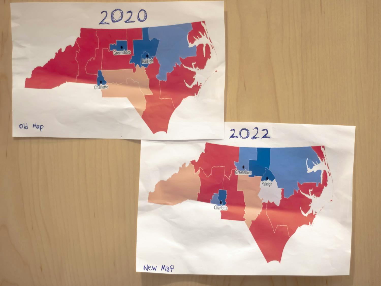 DTH Photo Illustration. A side by side comparison of North Carolina's gerrymandered map from 2020 and the map for the 2022 election.