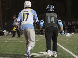 The men's lacrosse team scrimmaged Limestone on Thursday night, Jan. 28. So. William McBride (14) prepares to fight for the ball.