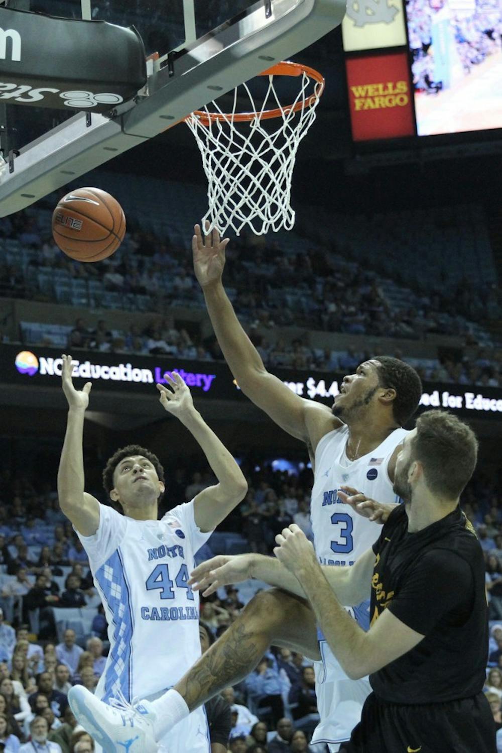 Justin Jackson (44) and Kennedy Meeks (3) go up for a rebound against Long Beach State Tuesday evening.&nbsp;