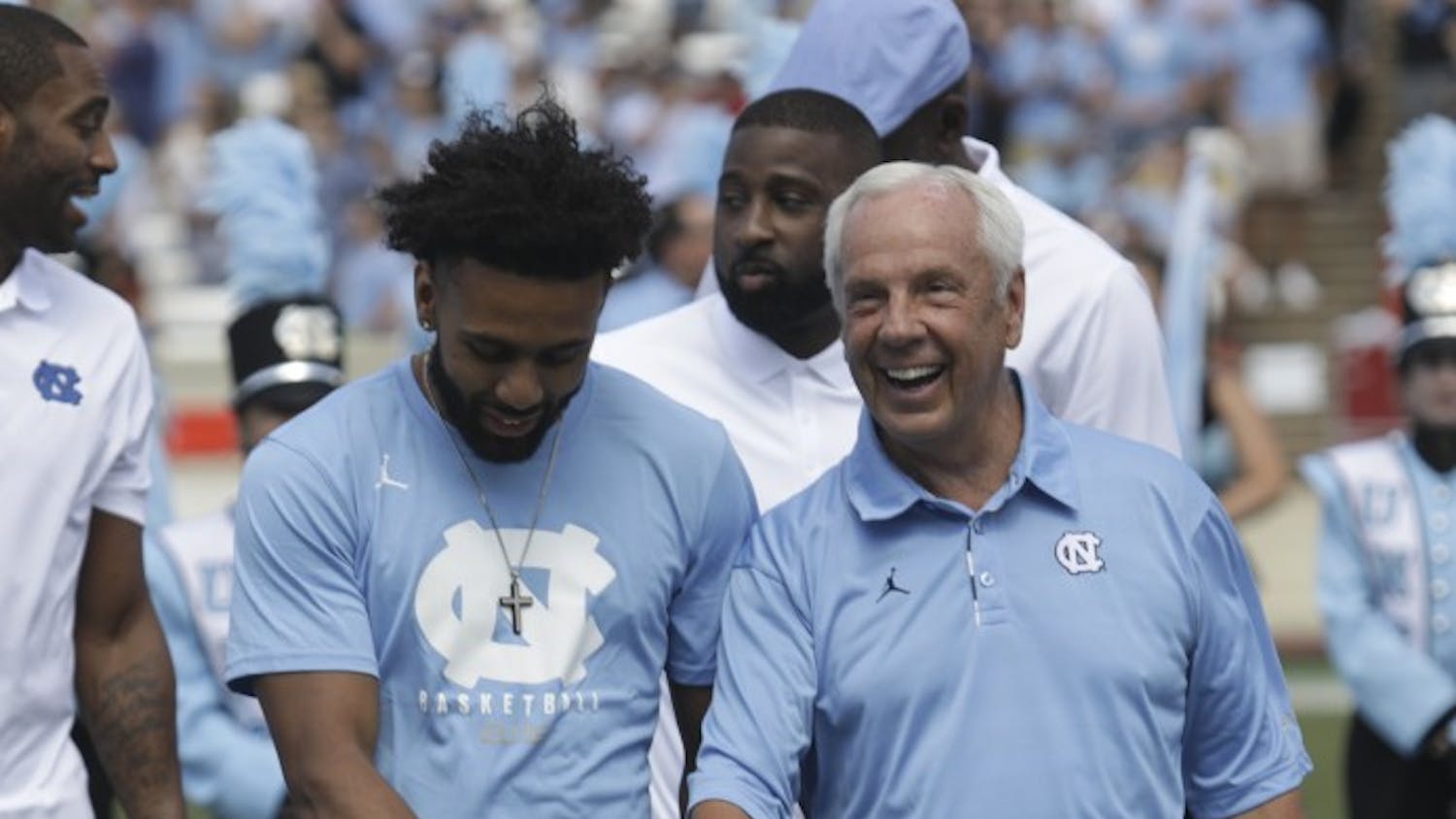 UNC senior point guard Joel Berry II (left) and UNC basketball head coach Roy Williams (right) show off their 2017 NCAA Men's Basketball championship rings during halftime of UNC's game against Louisville Saturday afternoon.&nbsp;