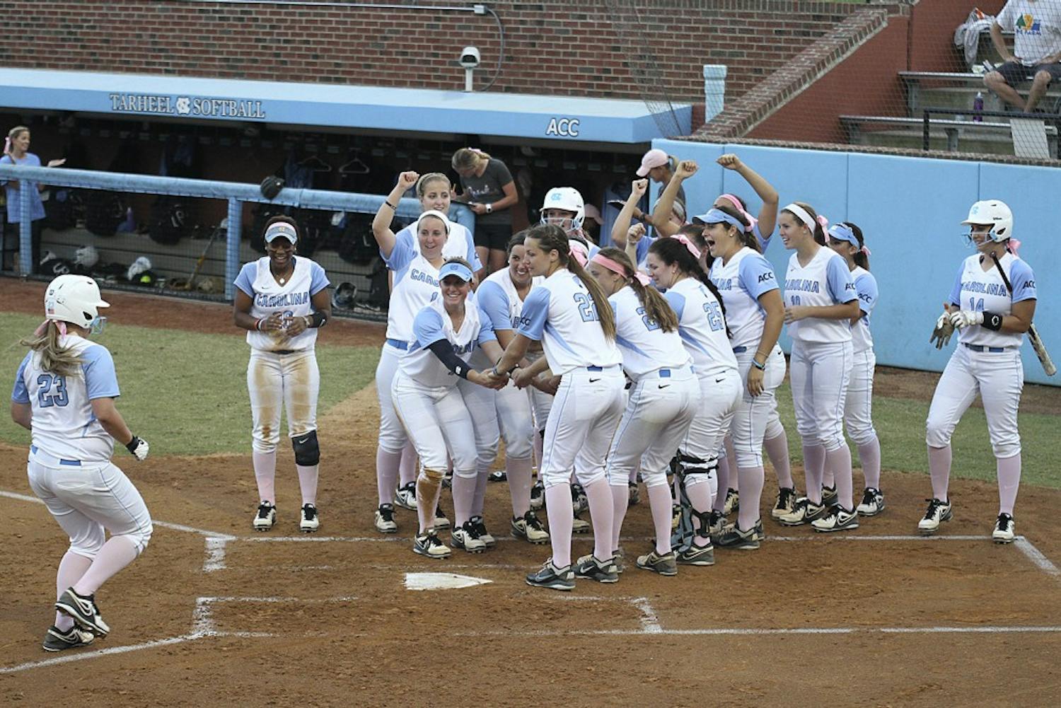 The team celebrates after Tracy Chandless, a junior from Canyon Country, California hits a home run during a preseason game against North Carolina Central University on October 8.
