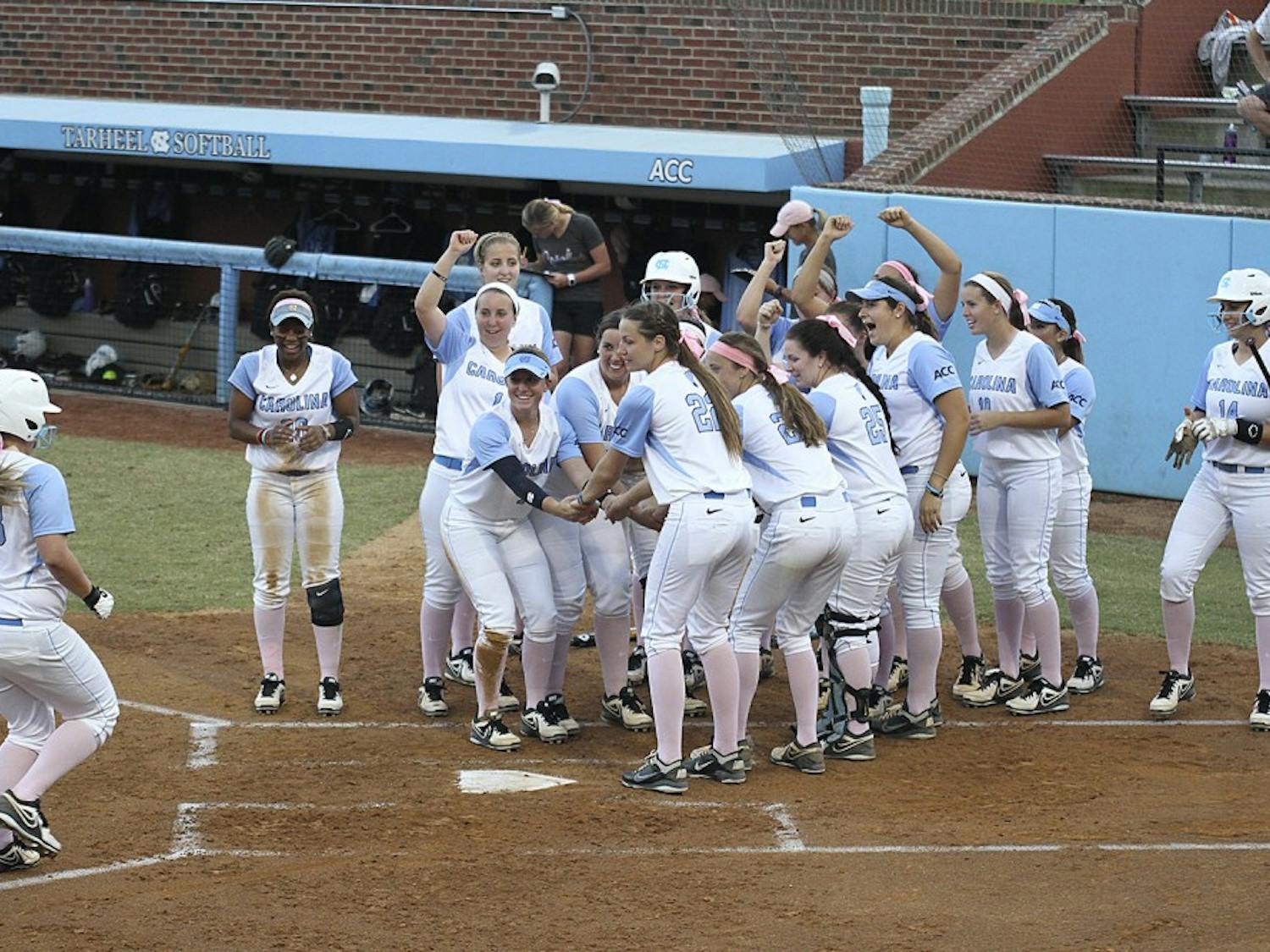 The team celebrates after Tracy Chandless, a junior from Canyon Country, California hits a home run during a preseason game against North Carolina Central University on October 8.
