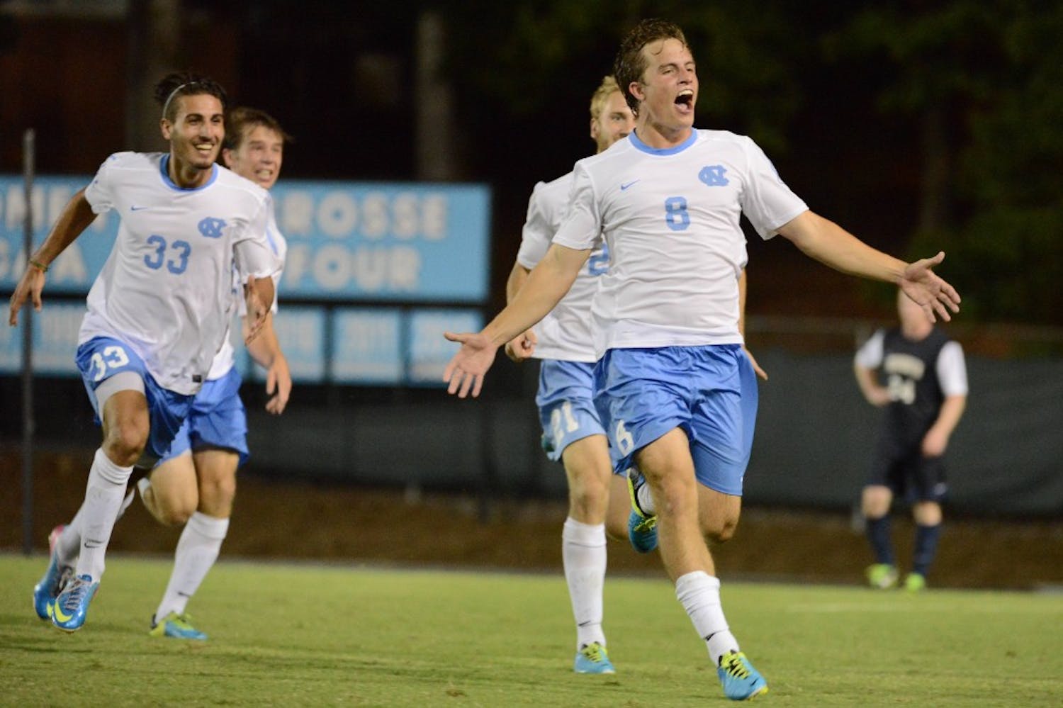 UNC forward Tyler Engel (8) celebrates after scoring the game winning goal in the second overtime period.