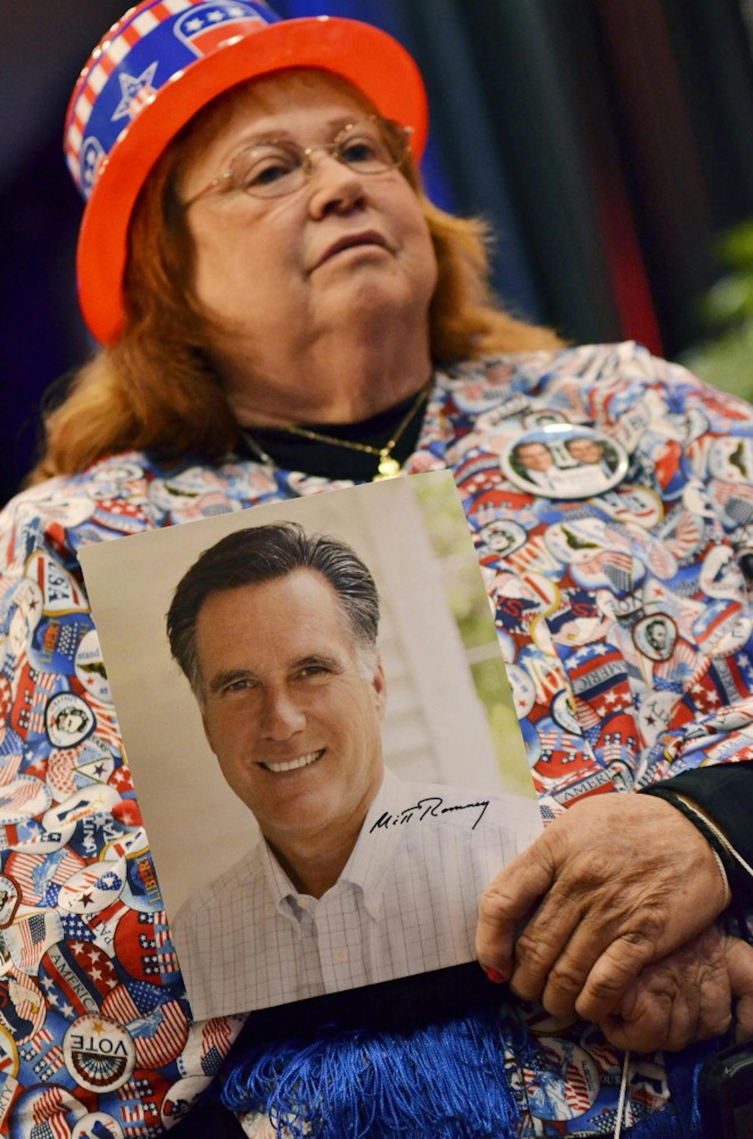 Lee Churchill seen holding a Romney photograph in her home made 
