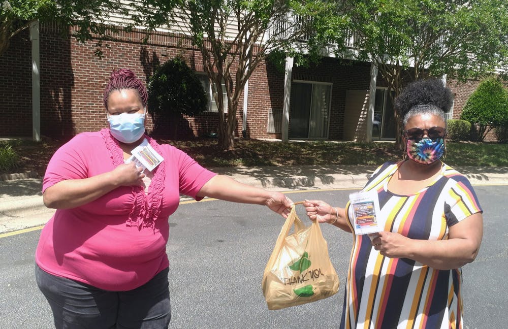 Volunteers Lorie Clark and Letitia Davison distributed masks at Carolina Spring Senior Apartments in Carrboro. Photo courtesy of Catherine Lazorko.
