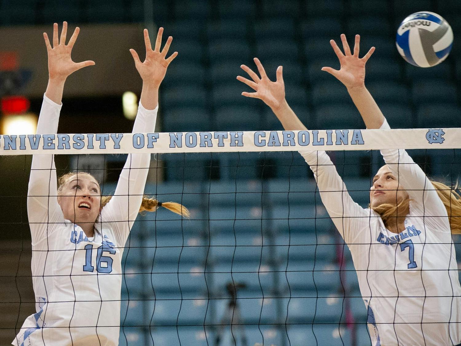 Grad Student Right Side Emily Zinger (16) and Senior Middle Hitter Amanda Phegly (7) jump to block the ball in the UNC win against Elon University on September 14, 2021.