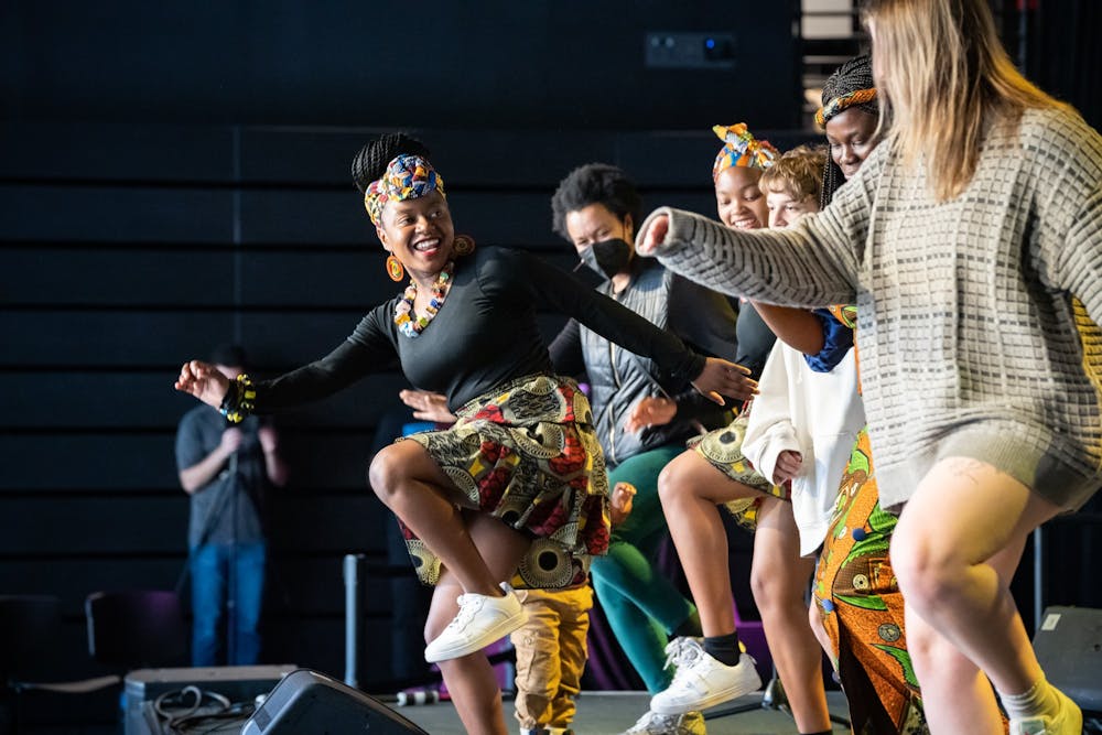 Members of the a capella group Black Umfolosi dancing with members from the audience during Africa Fest on Oct. 15, 2022 at the CURRENT ArtSpace.