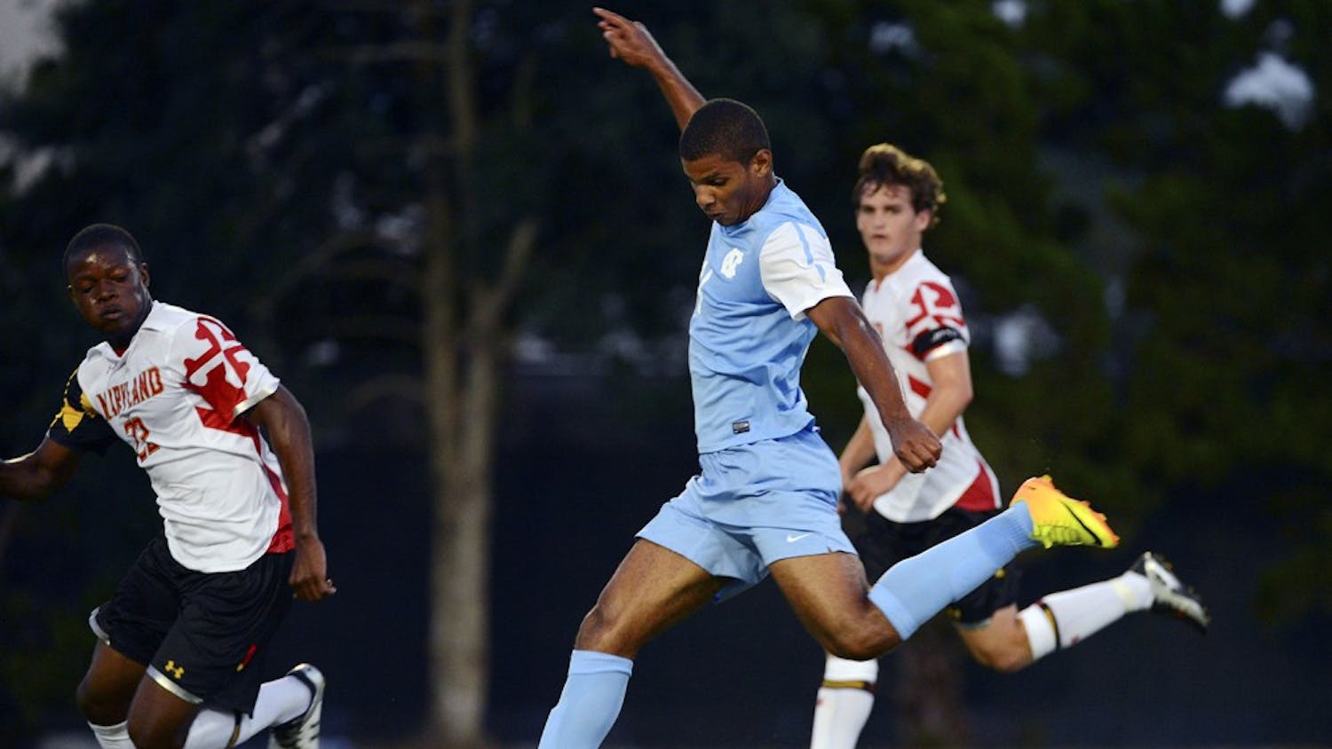 UNC midfielder Omar Holness (14) scores a goal.