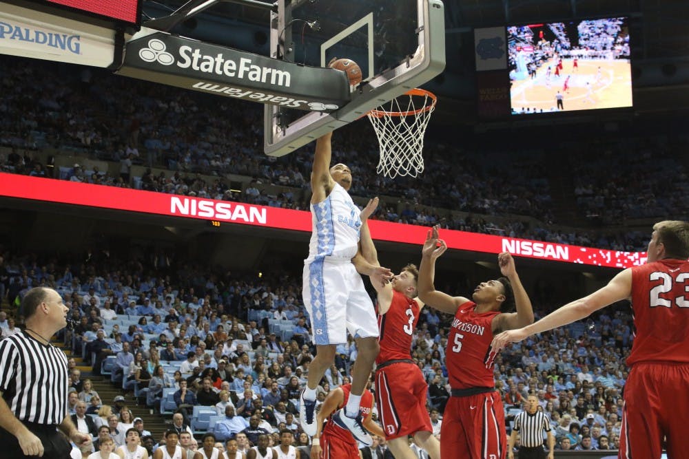 <p>Forward Brice Johnson (11) lays the ball in during UNC's 98-65 route of Davidson.</p>