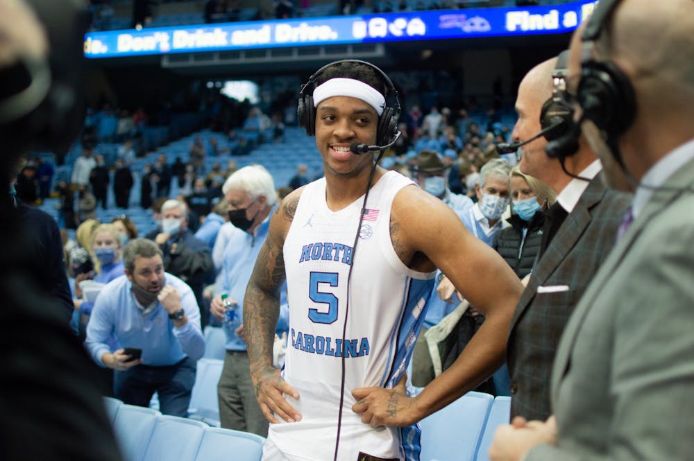 <p>Junior forward Armando Bacot (5) is interviewed by broadcasters after his career-high 29 point performance at the game against Virginia at the Smith Center in Chapel Hill on Jan. 8, 2022. UNC won 74-58.</p>