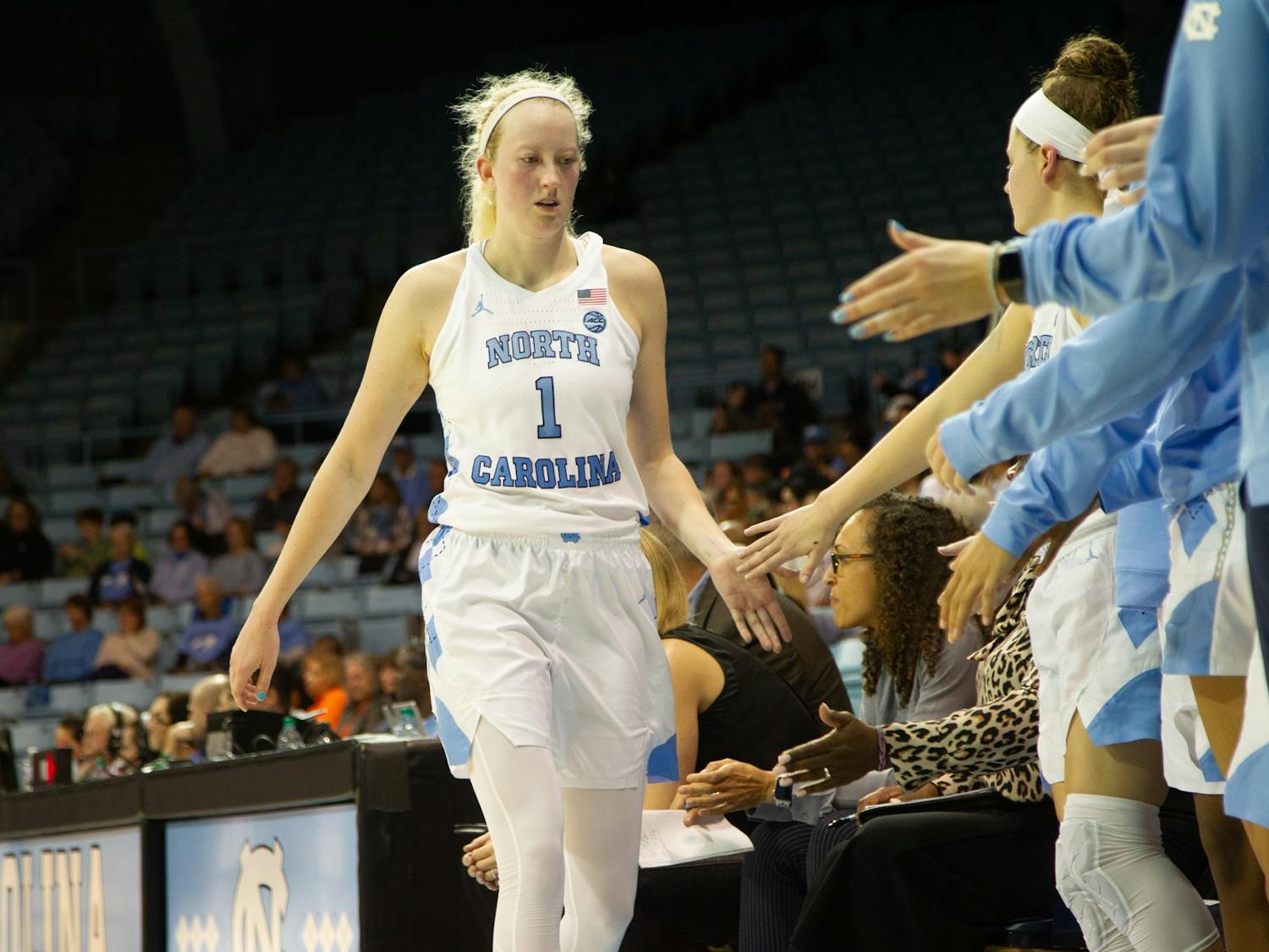 UNC senior guard Taylor Koenen (1) high-fives her teammates after the 3rd quarter during a game in Carmichael Arena on Thursday, Feb. 13, 2020. The Orange beat the Tar Heels 74-56.