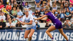 Graduate student midfielder Ally Mastroianni (12) cradles the ball during UNC's NCAA Tournament semifinal match against Northwestern at Homewood Field in Baltimore, M.D. on May 27, 2022. UNC won 15-14.