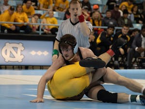 Redshirt Senior A.C. Headlee (157') attempts to pin his opponent in the UNC wrestling match against Appalachian State on Sunday, Dec. 1, 2019. Headlee's upset victory helped UNC to a 19-13 victory. &nbsp;&nbsp;