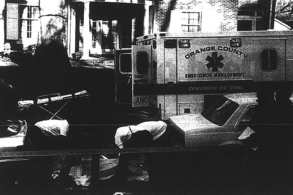<p>In 1995 a UNC law student shot and killed two people on Henderson Street. Orange County emergency medical professionals transport the body of one of the shooting victims.</p>