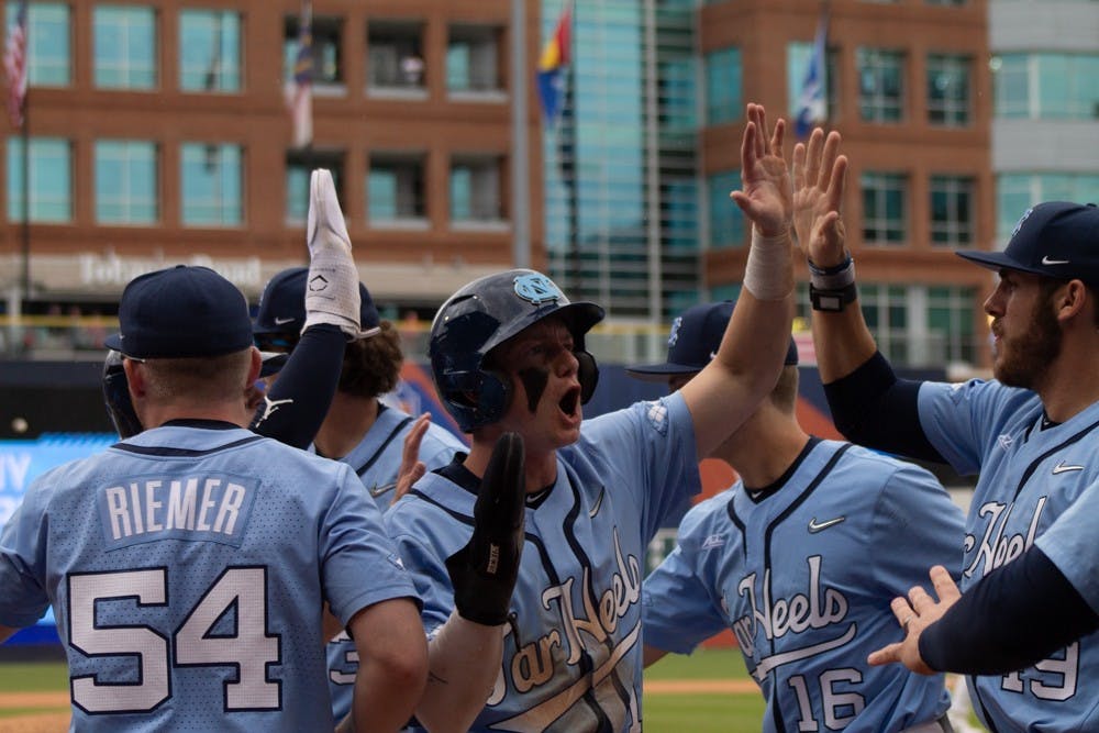 <p>The Diamond Heels celebrate a 10-2 win against the Virginia Cavaliers on Thursday, May 25, 2023 at the Durham Bulls Athletic Park.</p>