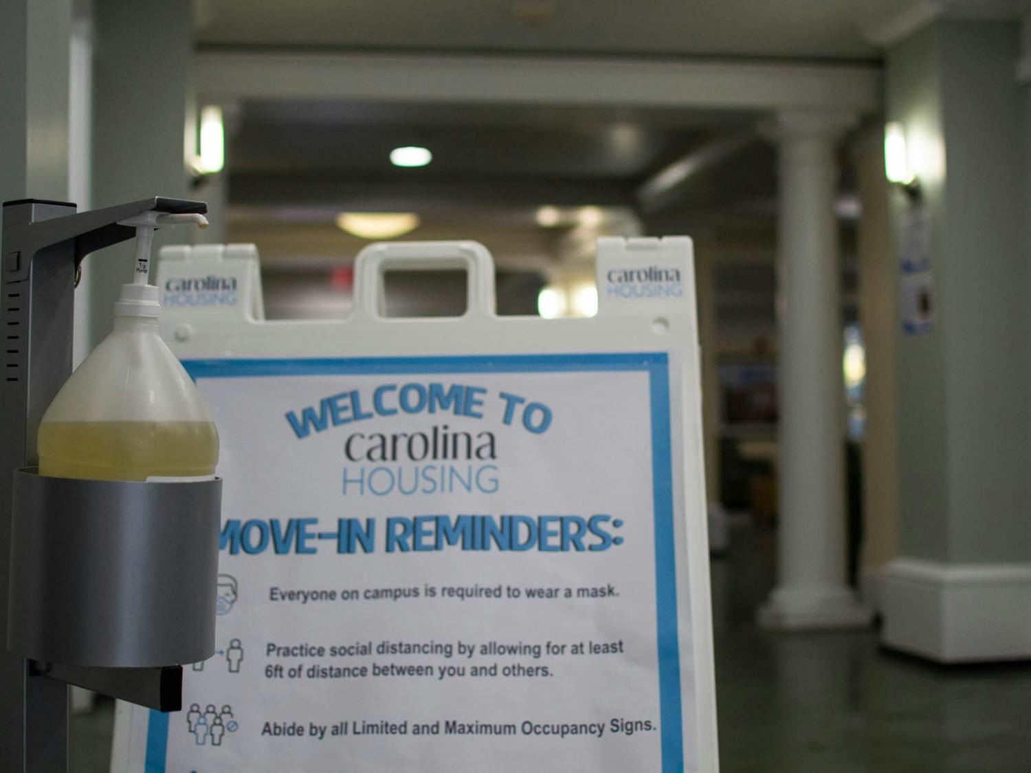 Hand sanitizer and instructions for a safe move-in sit in the front lobby of Cobb Residence Hall on Sunday, Nov. 15, 2020.