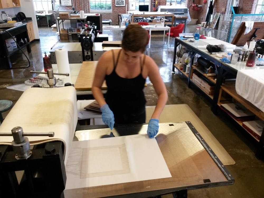 Jessica Jones is proofing a copper plate etching at Supergraphic. Photo courtesy of Jessica Jones.