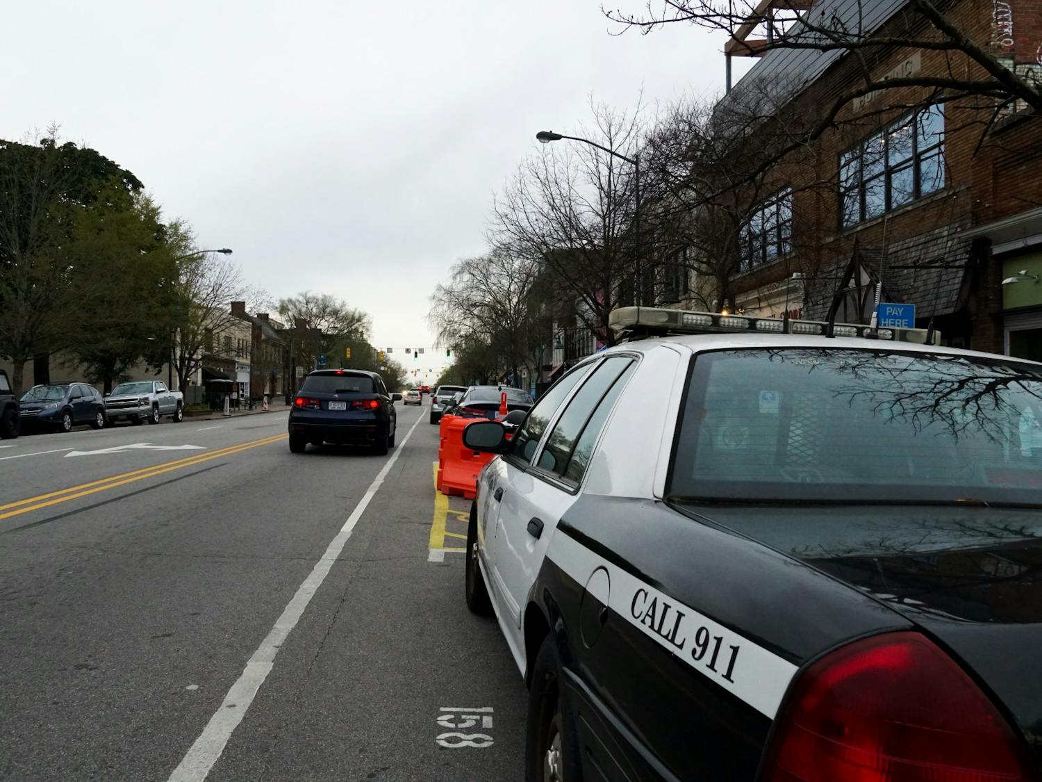 A City of Chapel Hill police car is parked on Franklin Street on Sunday, March 28, 2021. The town said that there would be more monitoring of pedestrian areas on main streets.