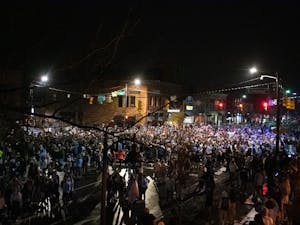 Students rush Franklin Street following UNC's 91-87 mens basketball victory over Duke. Hundreds of students gathered at the intersection of Franklin and Columbia despite COVID-19 restrictions.
